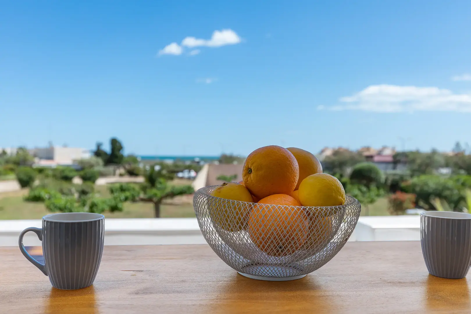 Breakfast on a terrace with sea view at Cap d’Agde Naturist Resort, fruit bowl and coffee