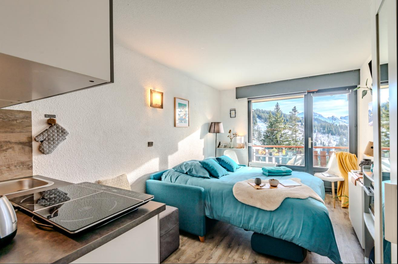 Kitchen area and bed with mountain view